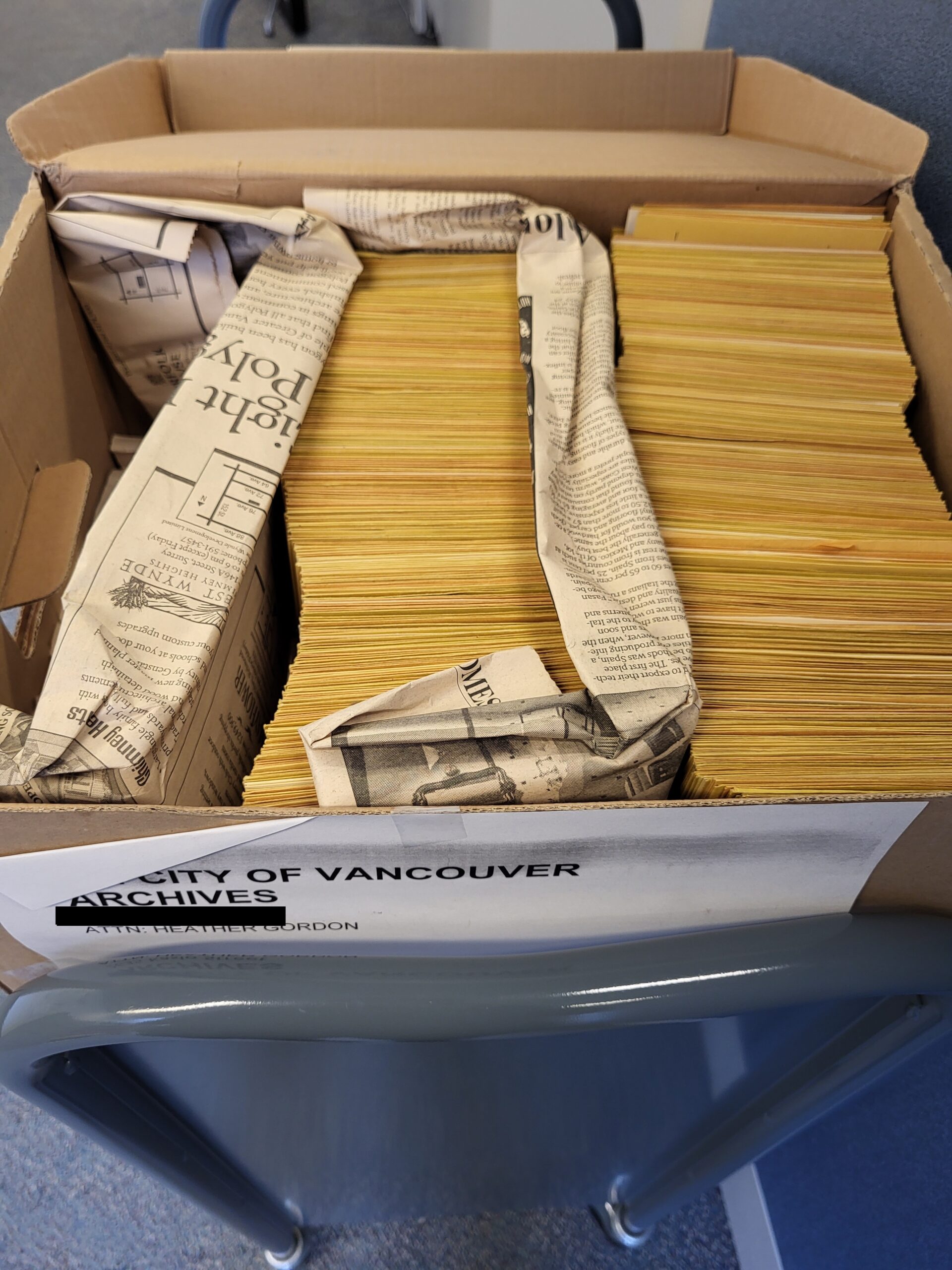 The “Before” state—a banker’s box full of photo assignment envelopes