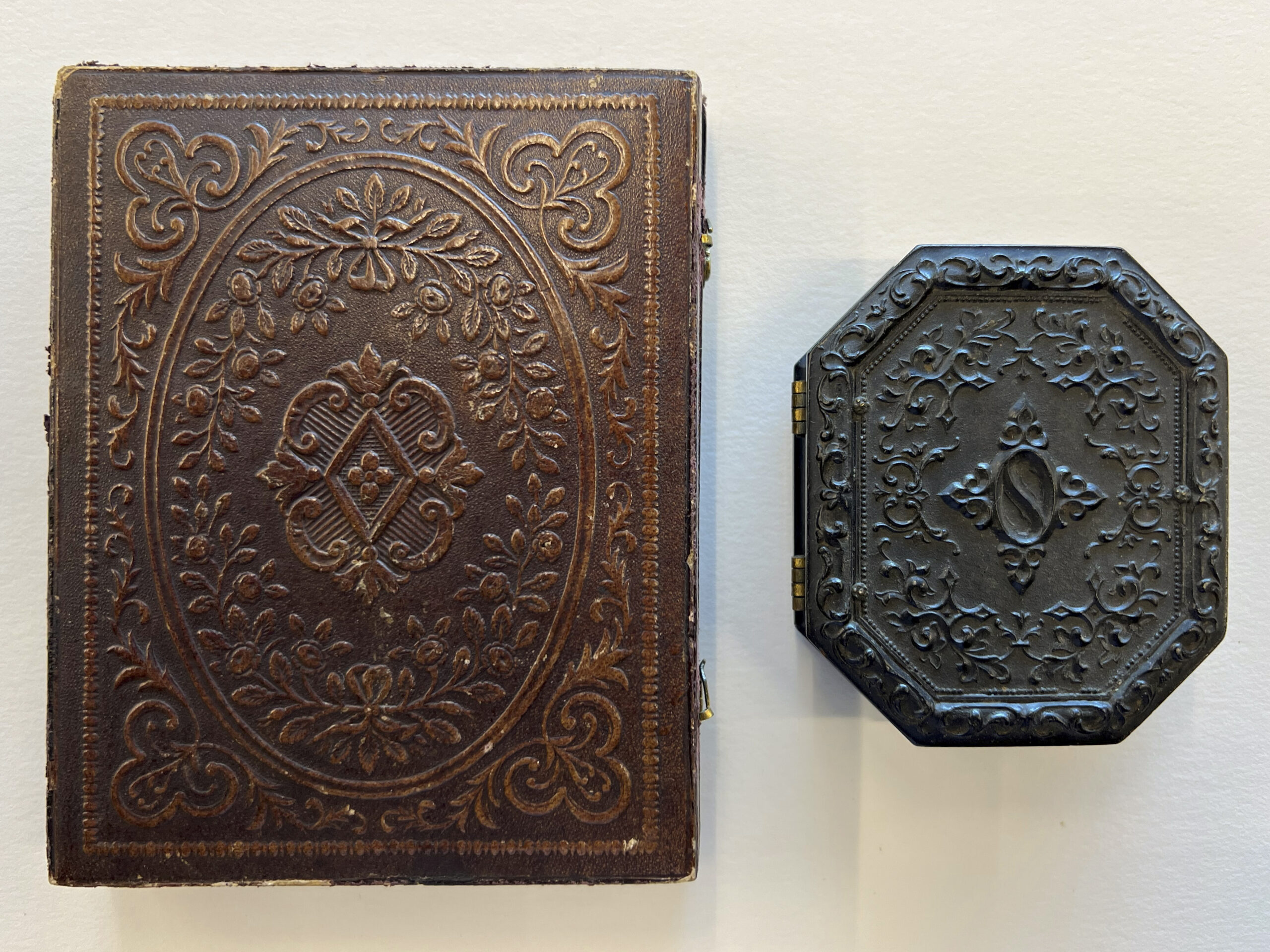 Examples of ornate cases: (Left) Tooled leather covering on a wooden case from the Rogers Family fonds (AM1368). (Right) A Union case from the Thomas Wicks fonds (AM236). Photo: Dorcas Tong.